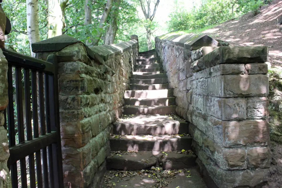Old sandstone stairs between sandstone block walls